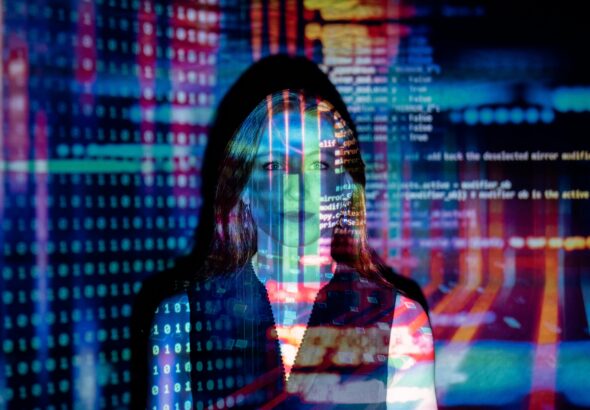 A woman with digital code projections on her face, representing technology and future concepts.